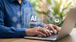 © Anjana444 - Person typing on laptop with AI ethics technology digital hologram interface