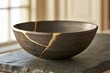 © Generative AI - Dark ceramic bowl with gold kintsugi repair on