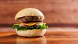 © Bangkok Click Studio - Delicious cheeseburger layer with golden bun juicy meat beef or pork patty melted cheddar cheese on wooden table background fresh ingredients green lettuce tomatoes tasty classic burger junk fast food