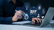 © Kiti - Businessman working on laptop with virtual RFP request for proposals graphics