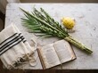 © AI img - A high-angle view of the Four Species used during the Jewish holiday of Sukkot, including a lulav with etrog, an open prayer book, and a tallit shawl placed on a rustic white wooden table.