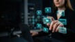 © Nuttawut - Digital Information Management: A professional woman interacts with a futuristic holographic interface, organizing digital files and data in a dark, modern office environment.