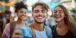 © Mariya - three young friends taking a street selfie in a busy urban setting wearing casual clothes and backpacks, daylight bokeh and a cheerful energetic mood