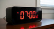 © nirwati - LED digital table clock with minimalist black casing that displays 07:00.