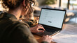 © Marvel’s Nook - Woman completing an online job application on a laptop with printed documents beside her, illustrating job search, recruitment and career application process.