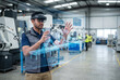 © Jahangir - Engineer using augmented reality headset for industrial machine maintenance in a factory