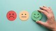 © Amena - Hand holding a green happy smiley face icon for customer feedback