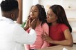 © Prostock-studio - Worried African American Girl Looking Up While Pediatrician Examines Her Neck, With Concerned Mother Sitting Beside, In A Modern Clinic Setting. Healthcare Concept.