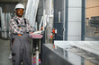© Serhii - African american worker standing in window factory