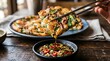 © Laxmi - A person using chopsticks to dip a piece of crispy korean scallion pancake into spicy soy sauce