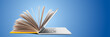 © fotofabrika - E learning concept showing a laptop and an open book representing online education and digital learning
