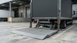 © White Craft  - Steel hydraulic tail lift platform on a delivery truck at a commercial loading dock.