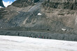© Tom - Small group of unrecognizable hikers walking in a line across massive glacier ice