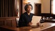 © Azorahaiá - Serious African American female judge in black robe holding documents in courtroom