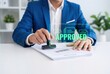 © tahir xh - Businessman stamping approved on document with digital overlay