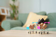 © Joi_studio - Shopping carts with package boxes and credit cards on table in home interior with copy space, online shopping, e-commerce, retail purchase, payment, consumer spending, order, shipping and delivery