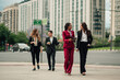 © Zamrznuti tonovi - Diverse business professionals walking and talking outdoors in city, collaborating and planning project