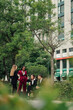 © Zamrznuti tonovi - Four businesspeople collaborating and networking outdoors in a city park, engaging in a relaxed discussion over coffee