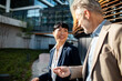 © Davor - Business colleagues walking and talking outside modern office
