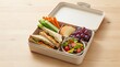© NextGen Canvas - Healthy lunch box with a fresh sandwich vegetable sticks grapes and a garden salad for school or work. nut free meal plan