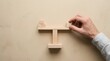 © Dedi Alfian studio - Hand balancing wooden blocks on scale structure over beige background, symbolizing business stability and strategic decision making.