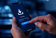 © Supto - Person using smartphone to download data with progress bar visible on screen in modern setting