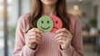 © FAHEEM - Woman holding green smiling and red sad emotion signs representing mood swings, mental health, emotional state, or customer feedback assessment