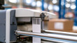 © A2Z AI  - Industrial barcode printer machine outputting a label with code stripes in a busy modern warehouse distribution and fulfillment center
