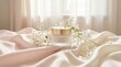 © rezaul4022 - Collagen cream jar with delicate white flowers on soft silk fabric background in morning light
