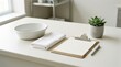 © rezaul4022 - Medical clinic desk arrangement with a white bowl towel clipboard and small succulent plant