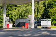 © K - Fuel dispensers stand in the shade of a filling station canopy featuring fuel prices economy supply chain gasoline, showing fuel retail infrastructure and forecourt equipment
