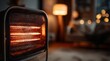 © Taiwo - Black electric radiant patio table heater with a glowing orange heating element inside a protective wire mesh guard.