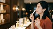 © SITI - Asian Woman Testing And Smelling Scent Strip In Luxury Perfume Boutique Store Counter With Bottles