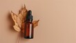 © iri.madrid.art - Amber dropper bottle autumn leaf on beige background for autumn cosmetic mockup and product design background. Horizontal banner. Copy space