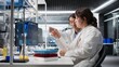 © DC Studio - Senior laboratory expert and trainee analyze a batch of blood samples for disease research and clinical testing, while the lab manager and intern examine blood sample vials for further testing.