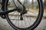 Close up view of a broken metal bicycle wheel spoke damaged on a road cycling trip requiring immediate repair and maintenance
