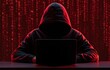 © Arfa_Media - Hacker in a hoodie using a laptop to commit cybercrime with digital binary code and internet security technology