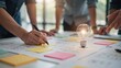 © Stock by Anika - Business team brainstorming new project ideas with a glowing light bulb on sketches. Creative problem solving and innovation concept for corporate strategy development.
