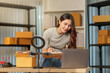 © Natee Meepian - Asian businesswoman checking online orders on laptop for e-commerce small business fulfillment