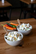 © Pixel-Shot - Healthy nutrition and clean eating, cottage cheese bowls with fresh vegetables for a balanced diet and weight loss meal plan on a wooden restaurant table