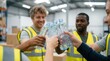 © Ronnayut - In an overheated warehouse during a summer heat emergency, a group of coworkers share ice water bottles and damp towels to ensure workplace safety and heat illness prevention.