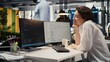 © DC Studio - Cheerful technician works in an office using specialized hardware to accelerate complex AI calculations; upbeat IT expert manages systems for machine learning training datasets and processing tasks.