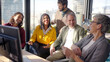 © CarlosBarquero - Diverse group of professionals laughing and talking during an informal meeting in a modern office. Bright corporate scene conveying teamwork, collaboration and positive workplace culture.