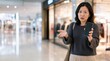 © rdkcho - Confused Asian Woman Holding Smartphone in Shopping Mall