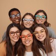 © Mahbub - Diverse group of happy young friends wearing stylish colorful eyeglasses posing together