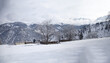 © Travel 'n' Lifestyle - View of snow-covered landscape with traditional stone houses and bare trees against a backdrop of majestic mountains in Kalam, Khyber Pakhtunkhwa, Pakistan.