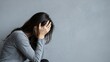 © mahrtgfx - Stressed woman covering her face with hands, expressing sadness and mental health struggle