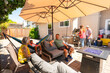 © Christine La/Stocksy - family hanging out in backyard