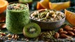 © fivan - A colorful healthy breakfast composition featuring a green detox smoothie beside overnight oats, kiwi slices, pumpkin seeds, almonds, and citrus wedges arranged on natural stone