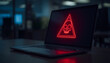 © Muhammad Umar - Laptop screen showing a red neon skull warning sign representing a cyber security threat.